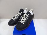 black and white sneakers with white laces on a blue box