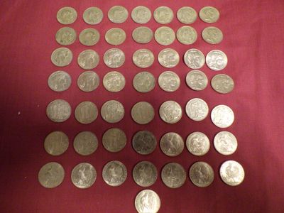 a lot of silver coins on a red cloth