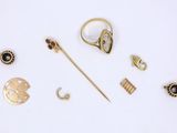 a lot of gold jewelry on a white surface
