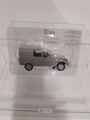 a toy car in a clear box on a table