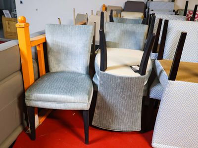 several chairs are lined up in a room with a red carpet