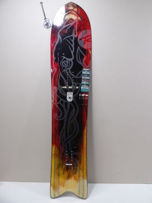 a snowboard that is hanging on a wall next to a lamp