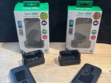three cell phones sitting on top of a wooden table next to a box