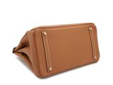 a tan leather purse with gold hardware on the front