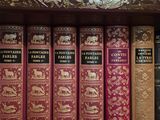 many books that are on a shelf in a library