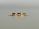 a close up of a gold ring with diamonds on a table