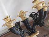 a black and gold candelier with candles on it