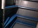 a blue shelf in the middle of a room