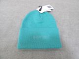 a blue beanie hat with a tag on it