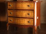 une petite commode en bois posée sur une table
