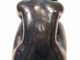 sculpture of a woman sitting on a stool with her back to the camera