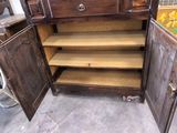a wooden cabinet with a door open in a room