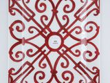 red and white plate with a decorative design on it