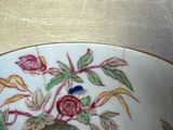 a bowl with a bird on it sitting on a table