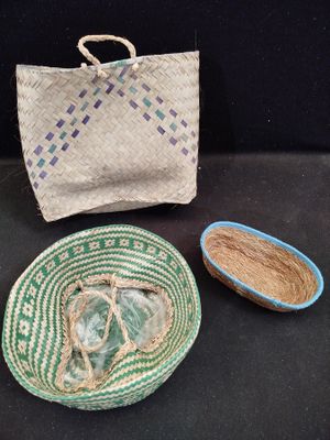 two baskets and a bag are sitting on a table
