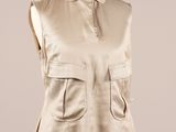a woman ' s beige vest on a mannequin mannequin