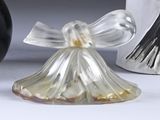 a glass angel figurine sitting next to a black and white vase