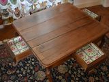 a wooden table with two drawers underneath it on a rug