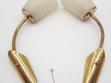 a pair of brass and white lamps on a white surface
