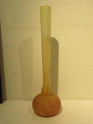 a yellow vase sitting on a white table