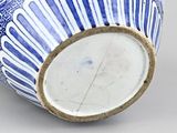 a blue and white vase sitting on a table