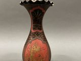 an image of a vase with a red and gold decoration