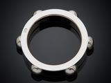 a close up of a silver ring on a black surface
