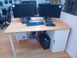 a desk with two computer monitors and a keyboard on it