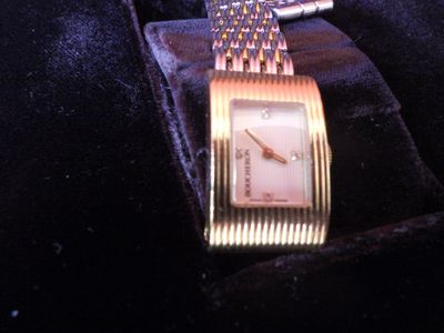 a watch that is sitting on top of a velvet case