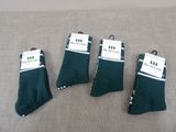three pairs of green socks are sitting on a couch
