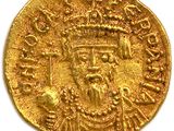 a close up of a gold coin on a white surface