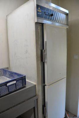 a white refrigerator in a kitchen next to a stove