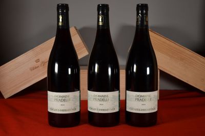three bottles of wine sitting next to a wooden box