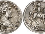 a silver coin with an image of a man on a horse