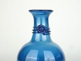 a blue vase that is sitting on a table
