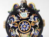 an image of a black and blue vase with flowers on it