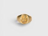 a gold signet ring with a roman coin in the center