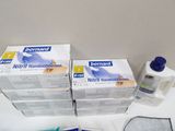 several boxes of hand sanitizer sitting on top of a white counter