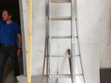 a man that is standing next to a ladder