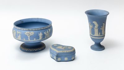 two blue vases and a small box on a white surface