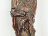 a statue of a woman sitting on a chair