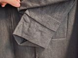 a close up of a person ' s hand pulling a piece of clothing out of a suit