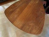 a wooden table with a wooden top on a tile floor