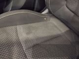 a close up of a car seat with a button on it