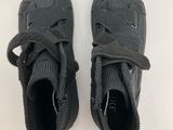 a pair of black sneakers with laces on them on a white surface