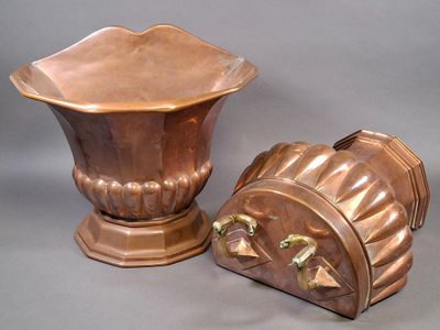 deux vases en cuivre posés l'un à côté de l'autre sur une table