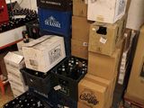 a lot of boxes and boxes of beer on the floor