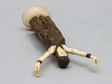 an image of a wooden figurine of a woman laying on her back