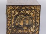 an old black and gold box with a painting on it
