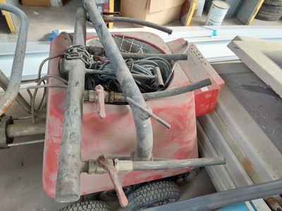 a red cart with a bunch of wires on it